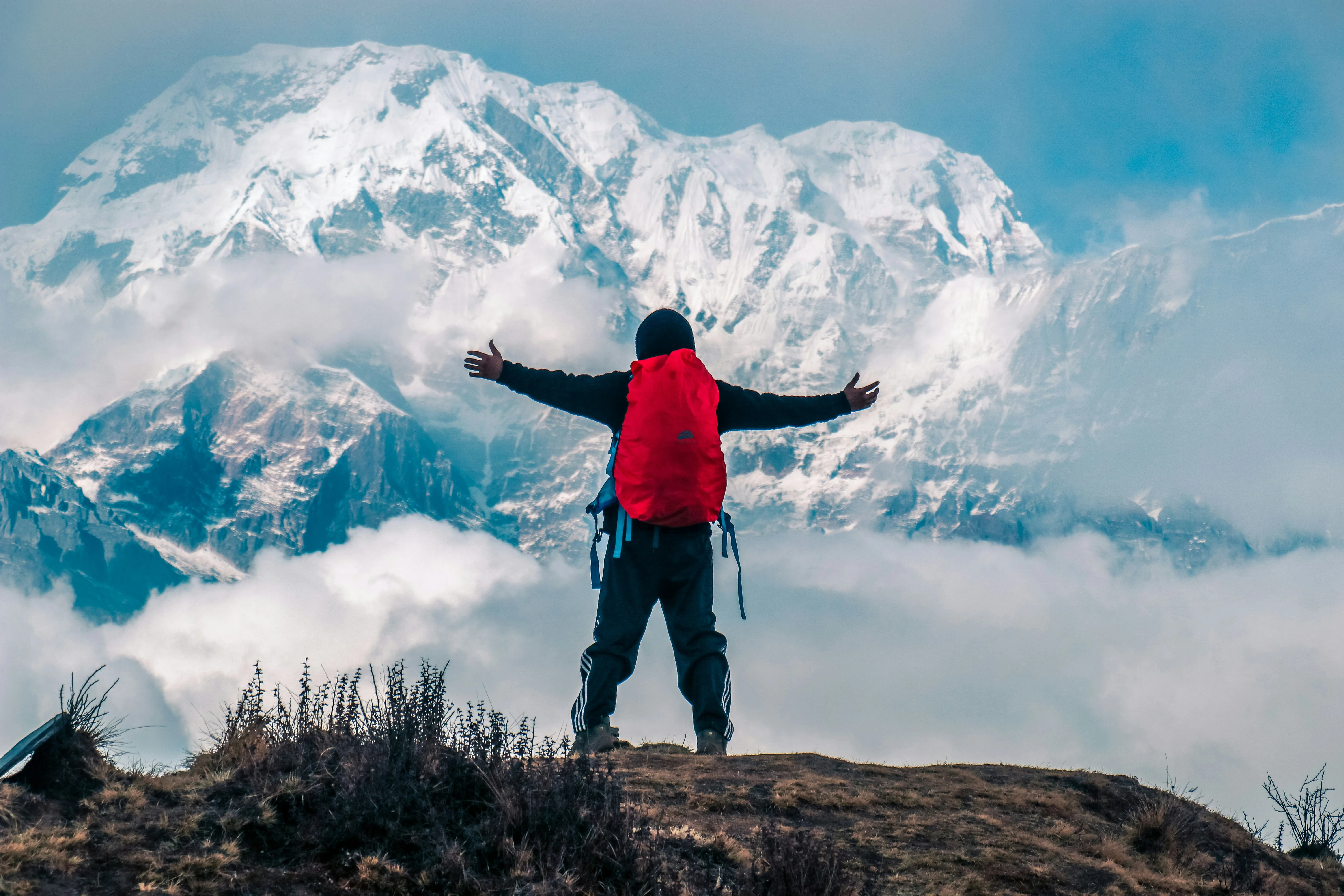 Trekker arms outstretched before Annapurna
